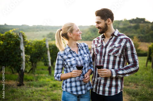 Woman and man in vineyard drinking wine © NDABCREATIVITY