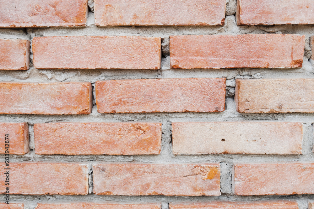 Obraz premium Close up photo of a red brick wall background