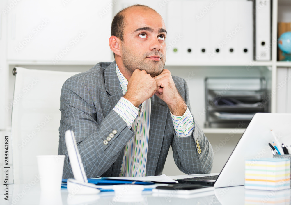Naklejka premium Sad businessman thinking about work