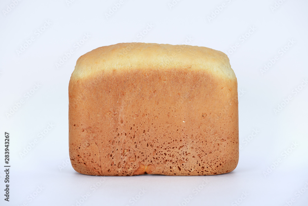 The hand-made bread made in bread baking machine on white background The hand-made bread made in bread baking machine on white background