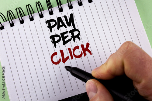 Text sign showing Pay Per Click. Conceptual photo Get money from visitors Ads Advertising SEO Marketing written by Man Notepad holding Marker the plain background. photo