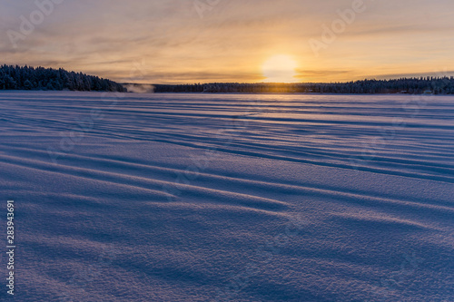 sunset over snowy landscape