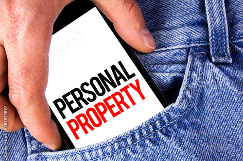 Conceptual hand writing showing Personal Property. Business photo showcasing Belongings possessions assets private individual owner written Mobile phone holding by man the Jeans background. photo