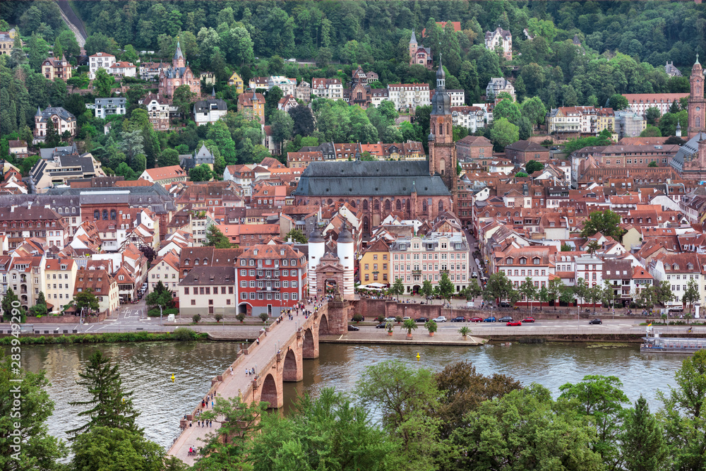 The historical old bridge gate with two towers in Heidelberg. In the background the Church of the Holy Spirit and the old town , Baden Wuerttemberg, Germany, Europe The historical old bridge gate with two towers in Heidelberg. In the background the Church of the Holy Spirit and the old town , Baden Wuerttemberg, Germany, Europe