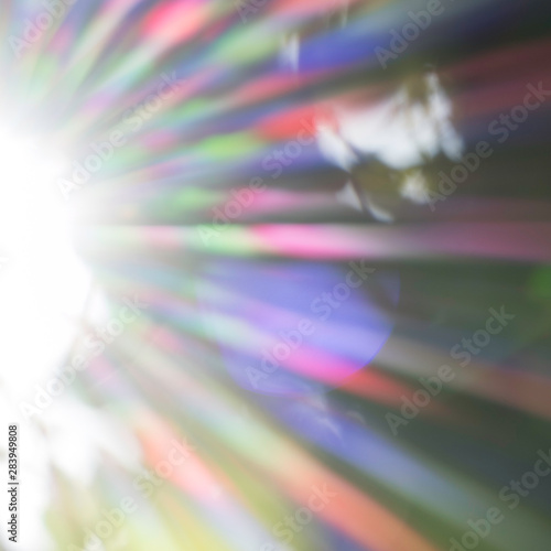 Abstract image of the sparkling sunrays. The visible light of the sun, in the colors red, orange, yellow, green, blue, indigo and violet. Bright and shiny beams of light.