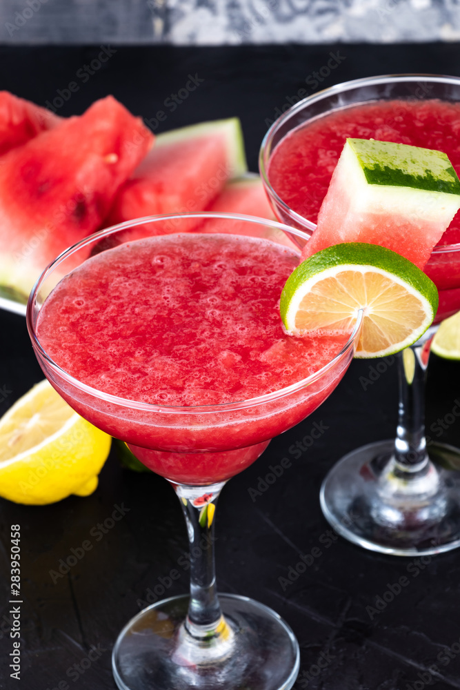 Two watermelon smoothies with slices of watermelon, lemon and lime Two watermelon smoothies with slices of watermelon, lemon and lime