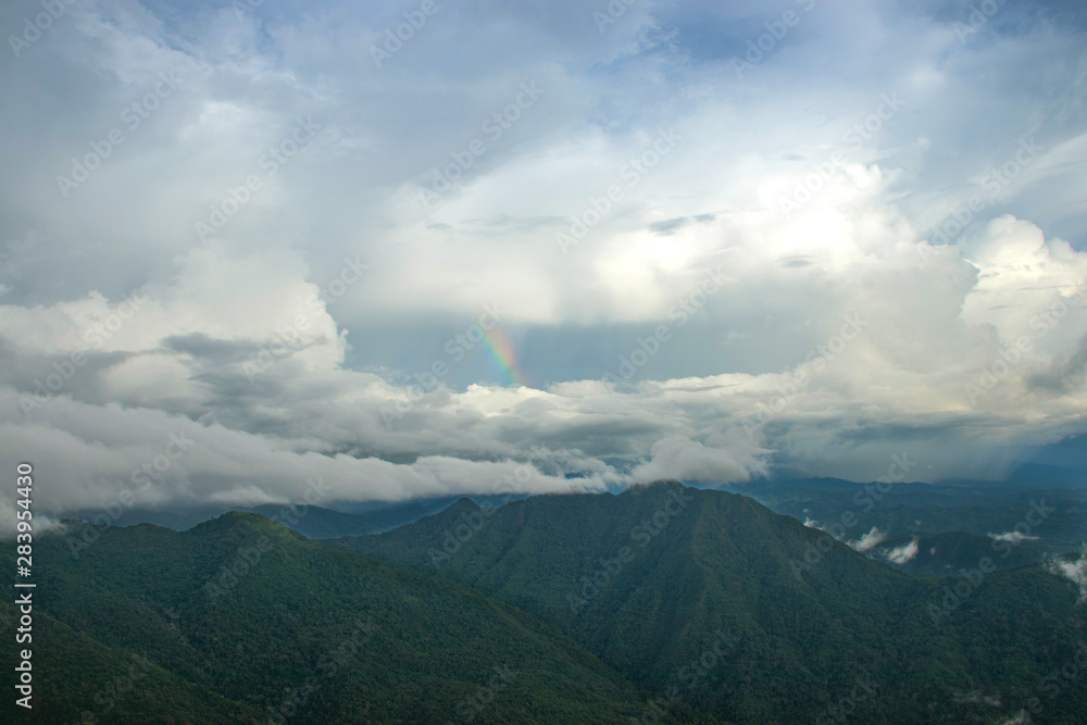 Fototapeta premium Mountain, sky, could and a little rainbow at the north of Thailand. (Nan)