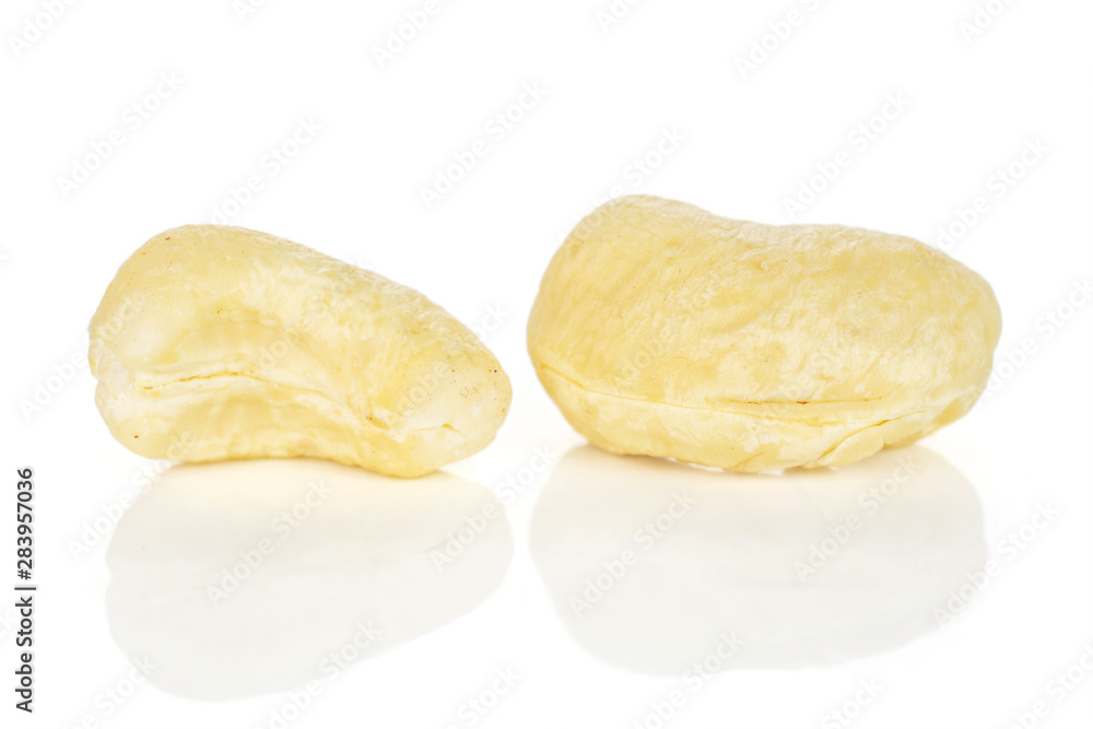 Group of two whole unsalted beige cashew isolated on white background