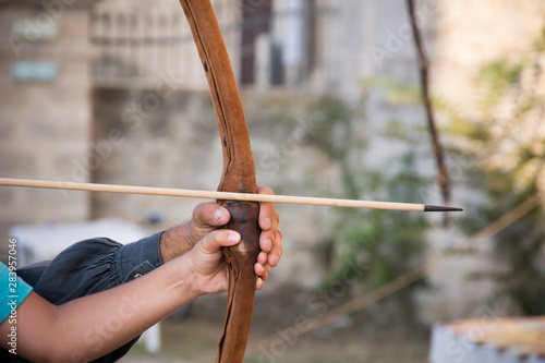 Close Up of Man Helping a Child to Shoot with Arc at Medieval Village Festival