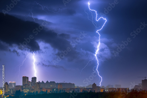 Lightning storm over the city at the summer heavy rain. Dramatic  breathtaking atmospheric natural phenomenon. Left bank outskirts of Kyiv  Ukraine.
