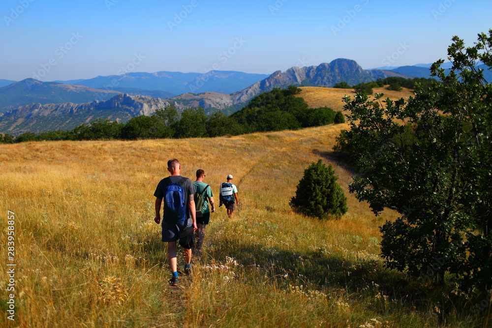 Tourists walking along the trail in the mountains