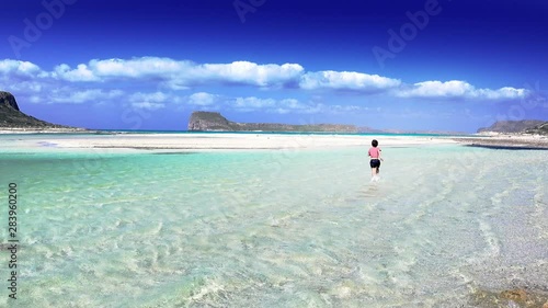 Boy running in water at beach