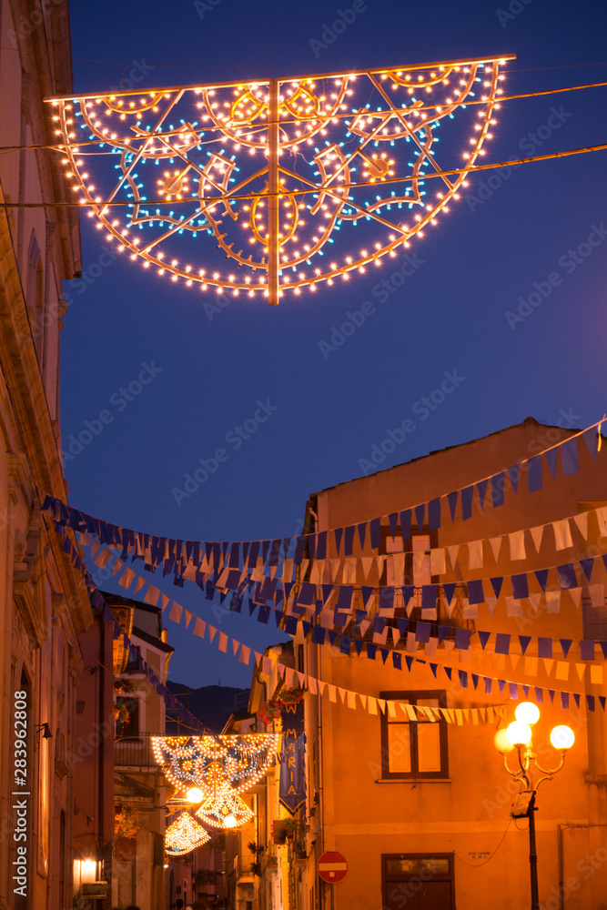 Obraz premium Narrow Alley Lightened at Blue Hour in the CIty of Rotonda, in the South of Italy