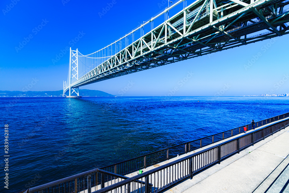 Landscape of family angler in the background of Akashi Kaikyo Bridge in the summer morning Landscape of family angler in the background of Akashi Kaikyo Bridge in the summer morning