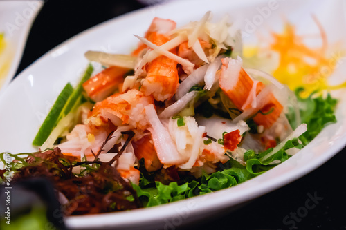 crab stick spicy salad in white dish, thai spicy food