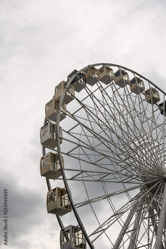Ferris wheel against the sky in cloudy weather Ferris wheel against the sky in cloudy weather