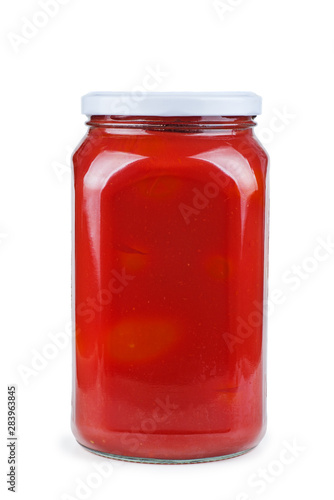 Glass jar with tomato juice isolated on white background