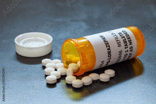 Prescription bottle with backlit Lorezapam tablets. Lorezapam is a generic prescription anti-anxiety medication. A concept for mental health. photo