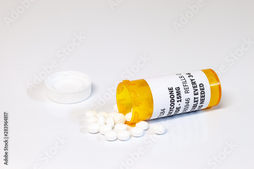 Prescription bottle with Oxycodone tablets isolated on a white background. Oxycodone is a generic prescription opioid. concept of the opioid epidemic