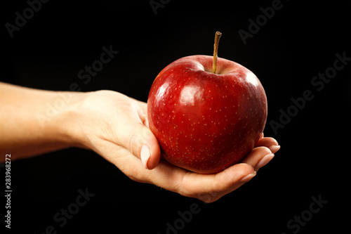 Red apple held in woma's hand