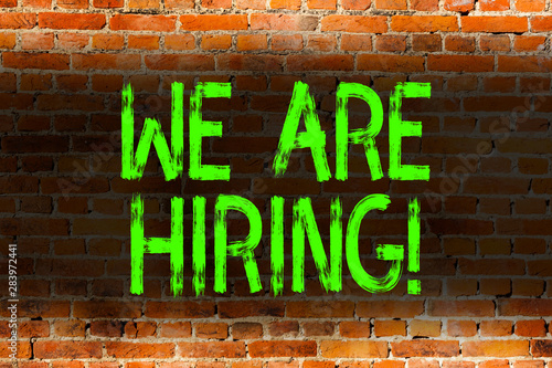 Text sign showing We Are Hiring. Business photo showcasing recently employ someone or pay him to do particular job Brick Wall art like Graffiti motivational call written on the wall