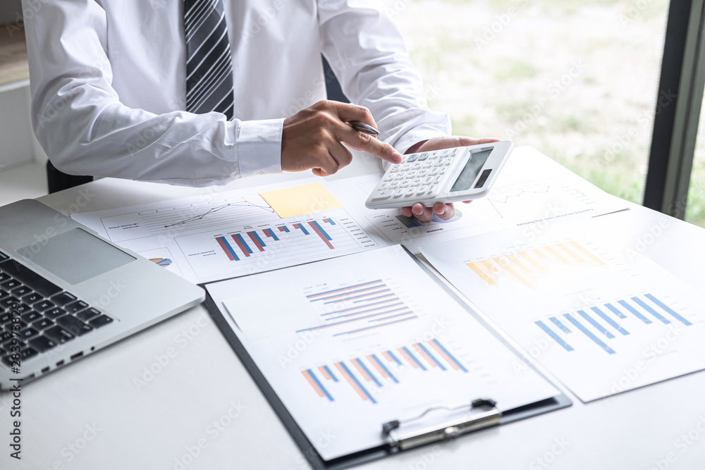 Businessman accountant working analyzing and calculating expense annual financial report balance sheet statement, doing finance making notes on report, Financing Accounting Banking Concept Businessman accountant working analyzing and calculating expense annual financial report balance sheet statement, doing finance making notes on report, Financing Accounting Banking Concept