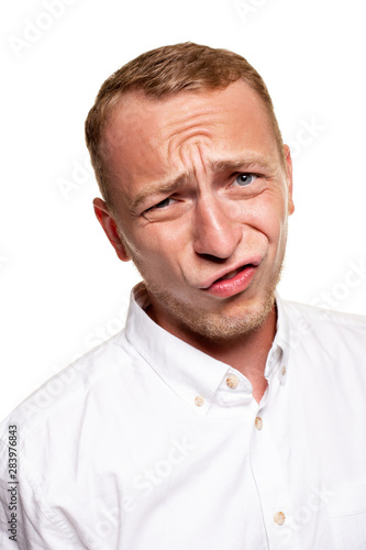 Handsome young blond man in a white shirt, isolated on a white background