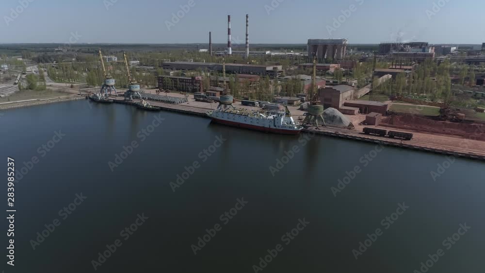 Cattle, cows loading from trucks into the cargo ship at the docks, industrial area. Aerial footage Cattle, cows loading from trucks into the cargo ship at the docks, industrial area. Aerial footage