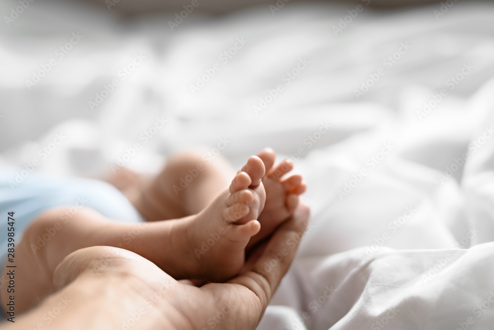 Macro plan little legs newborn baby in big men's palm father's, concept care, paternity, guardianship. Macro plan little legs newborn baby in big men's palm father's, concept care, paternity, guardianship.