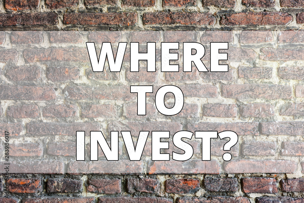 Fototapeta premium Writing note showing Where To Investquestion. Business concept for Right Place Stock Share to spend your savings in Brick Wall art like Graffiti motivational call written on the wall