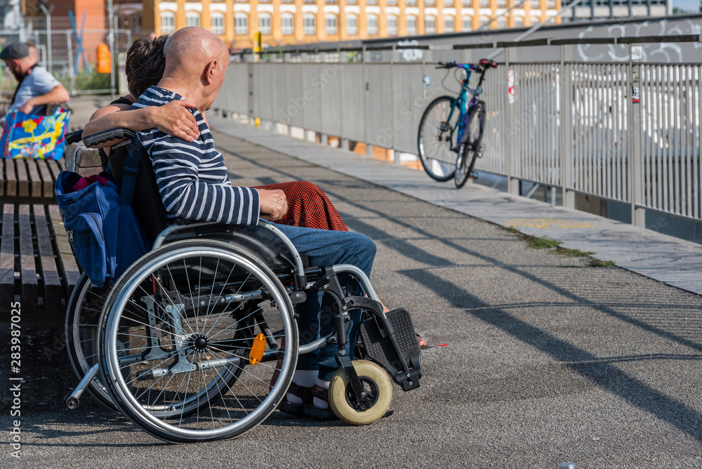 Obraz premium Woman, Man in a Wheelchair