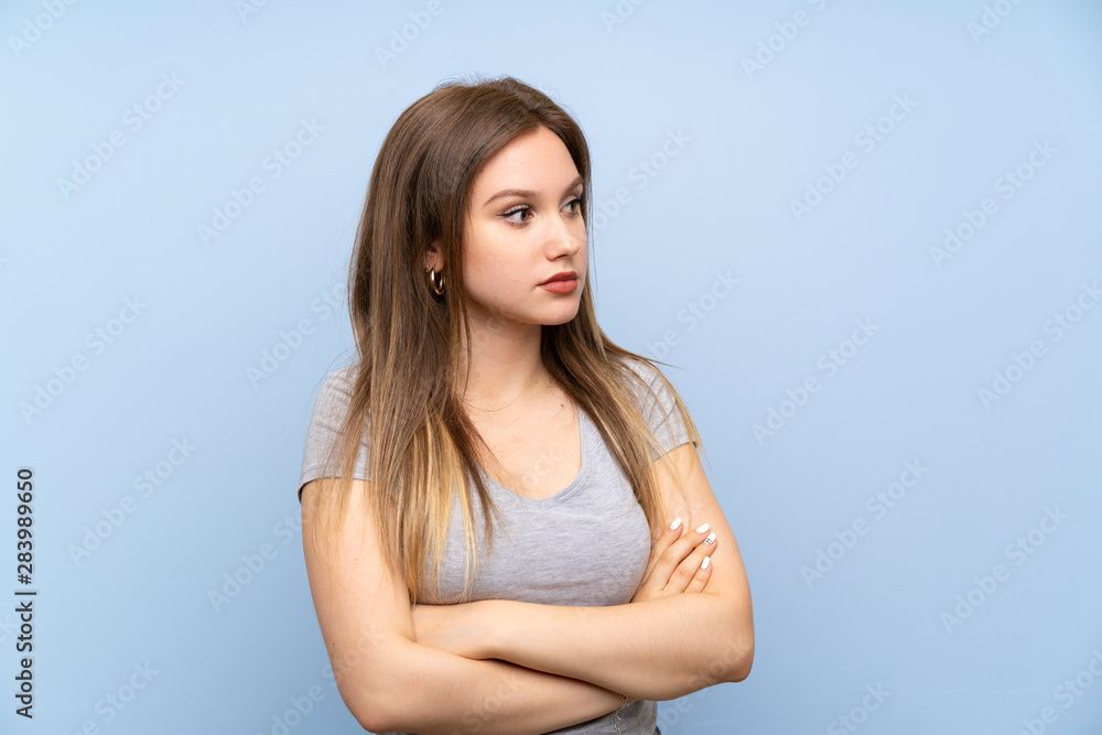 Teenager girl over isolated blue wall portrait Teenager girl over isolated blue wall portrait