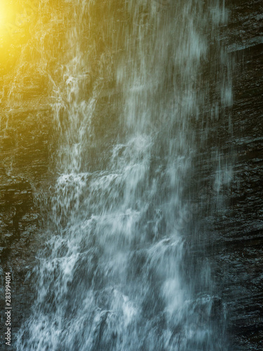 Big waterfall close-up from the top of the mountain. Sunset