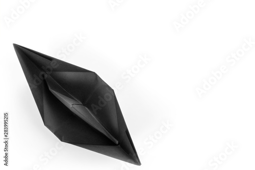 Black paper boat top view i...