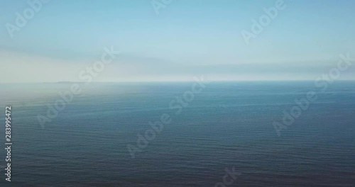 Fly over shot of a pacific coast during red tide photo