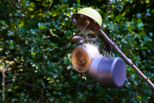 Drying mess tin hanging on a branch. Camping equipment. Scout camp
