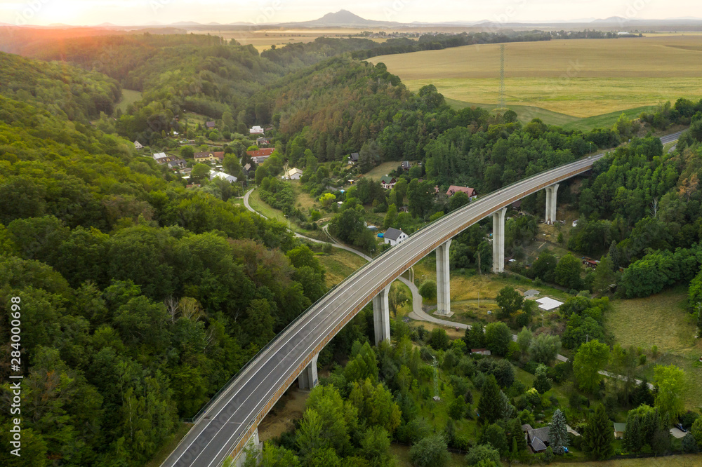 Aerial View of a Highway Bridge With Pillars in the Mountain or Hills With Trees