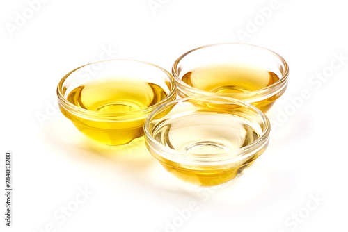 Vegetable, olive oil and apple vinegar in a bowl, isolated on white background