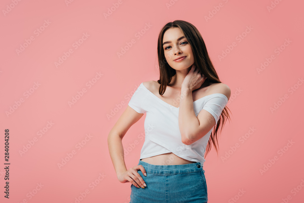 beautiful smiling girl posing with hand on hip isolated on pink beautiful smiling girl posing with hand on hip isolated on pink