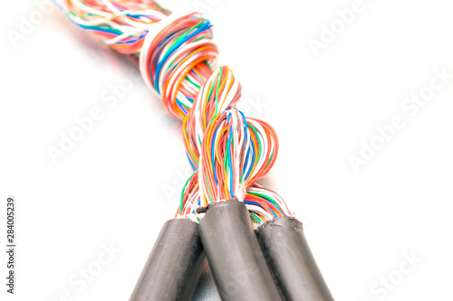 Three thick cables tangled in one big bundle of wires. Interlacing telecommunications telephone and Internet lines. Multi-colored wires Unshielded twisted pair photo