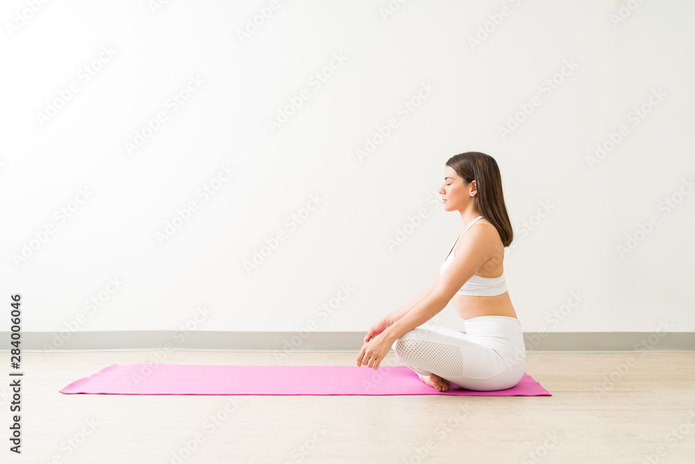 Woman Meditating In Easy Pose During Fitness Training Workout Woman Meditating In Easy Pose During Fitness Training Workout