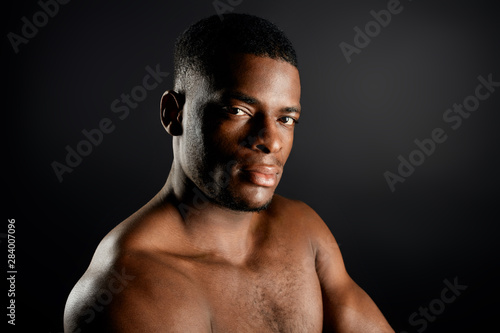 good looking American man with strict expression looking at the camera. close up portrait. studio shot. copy space