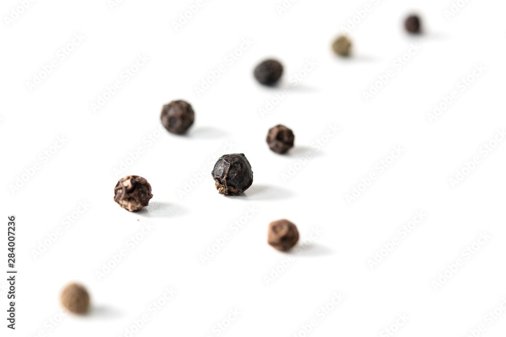 grains of black pepper on a white background grains of black pepper on a white background