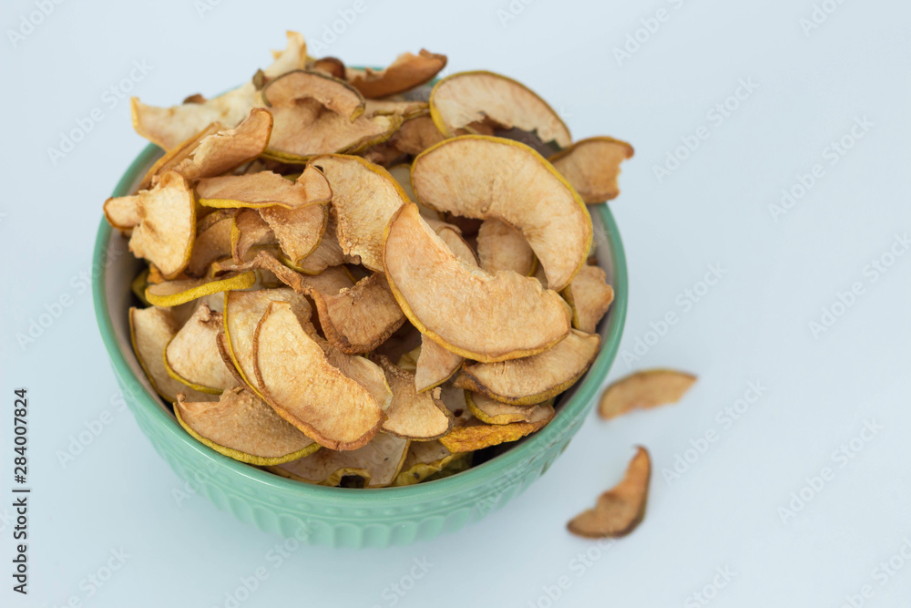 Apple quince chips in a green bowl isolated healthy food Apple quince chips in a green bowl isolated healthy food