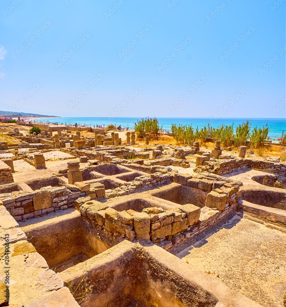 Garum sauce and Salting factories of Baelo Claudia Archaeological Site, with the Bolonia Beach in the background. Tarifa, Cadiz. Andalusia, Spain.