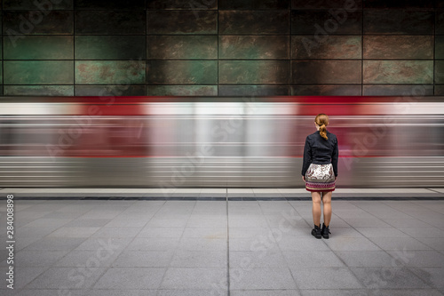 Girl in front of passing underground train