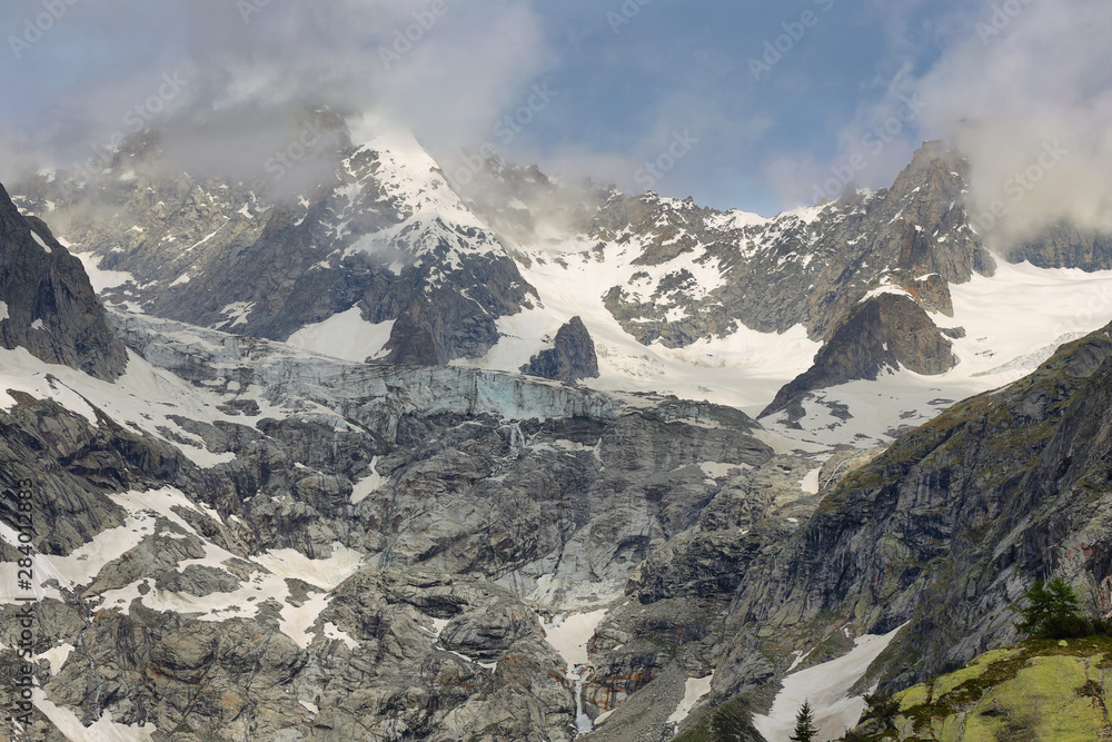View of mountain peaks with glaciers in Val Ferret, Aosta valley, Italy