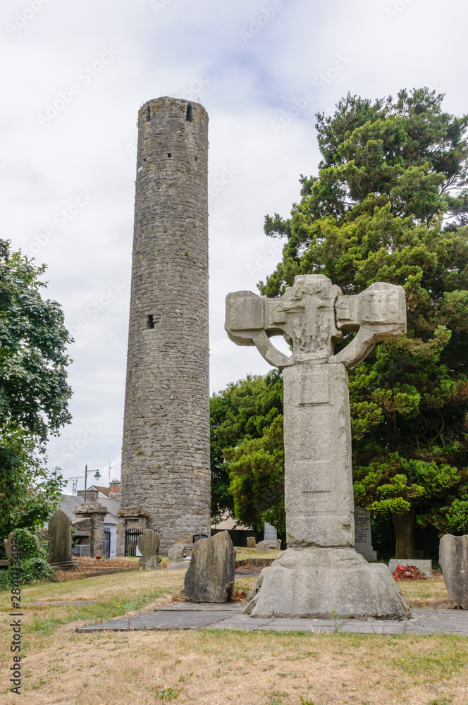 10th century roundtower and broken celtic cross, at Kells Abbey, Kells, County Meath, Ireland 10th century roundtower and broken celtic cross, at Kells Abbey, Kells, County Meath, Ireland