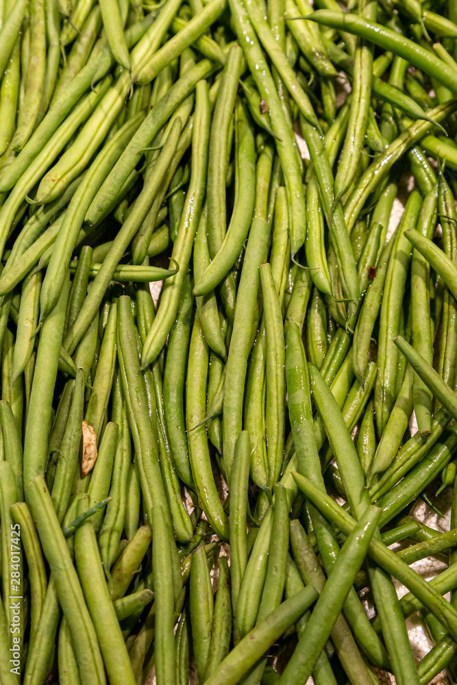 A full frame photograph of green beans for sale on a market stall A full frame photograph of green beans for sale on a market stall