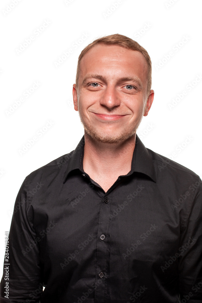 Obraz premium Handsome young blond man in a black shirt, isolated on a white background